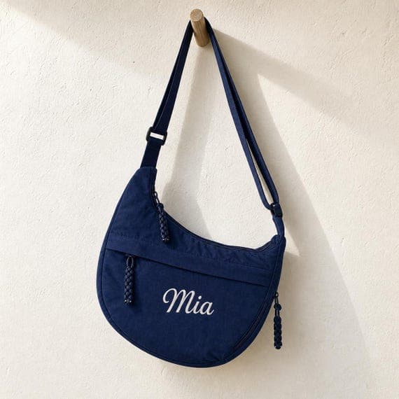 Embroidered crescent crossbody sling bag